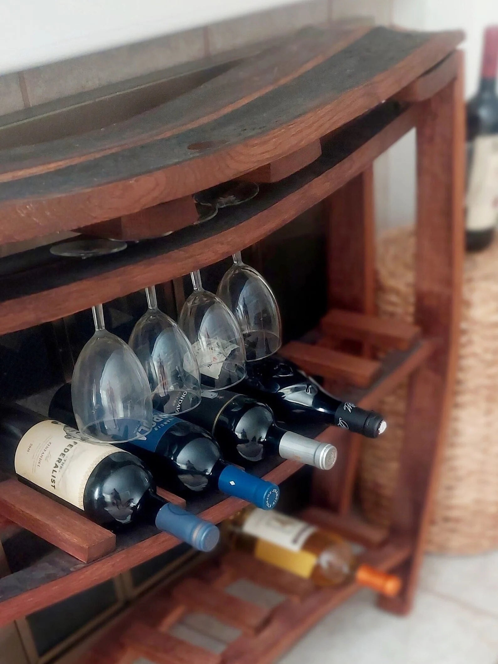 Elegant wooden wine rack with built-in wine glass holders, showcasing fine craftsmanship and timeless design for luxury interiors and wine lovers.