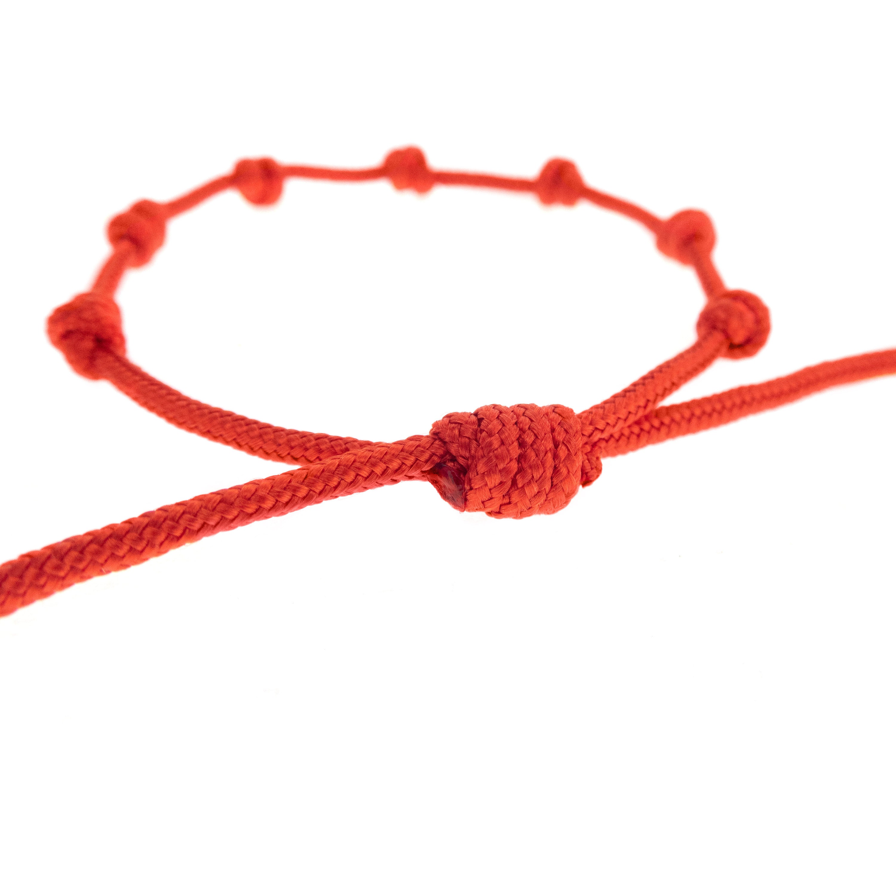 handmade red string bracelet with 7 knots