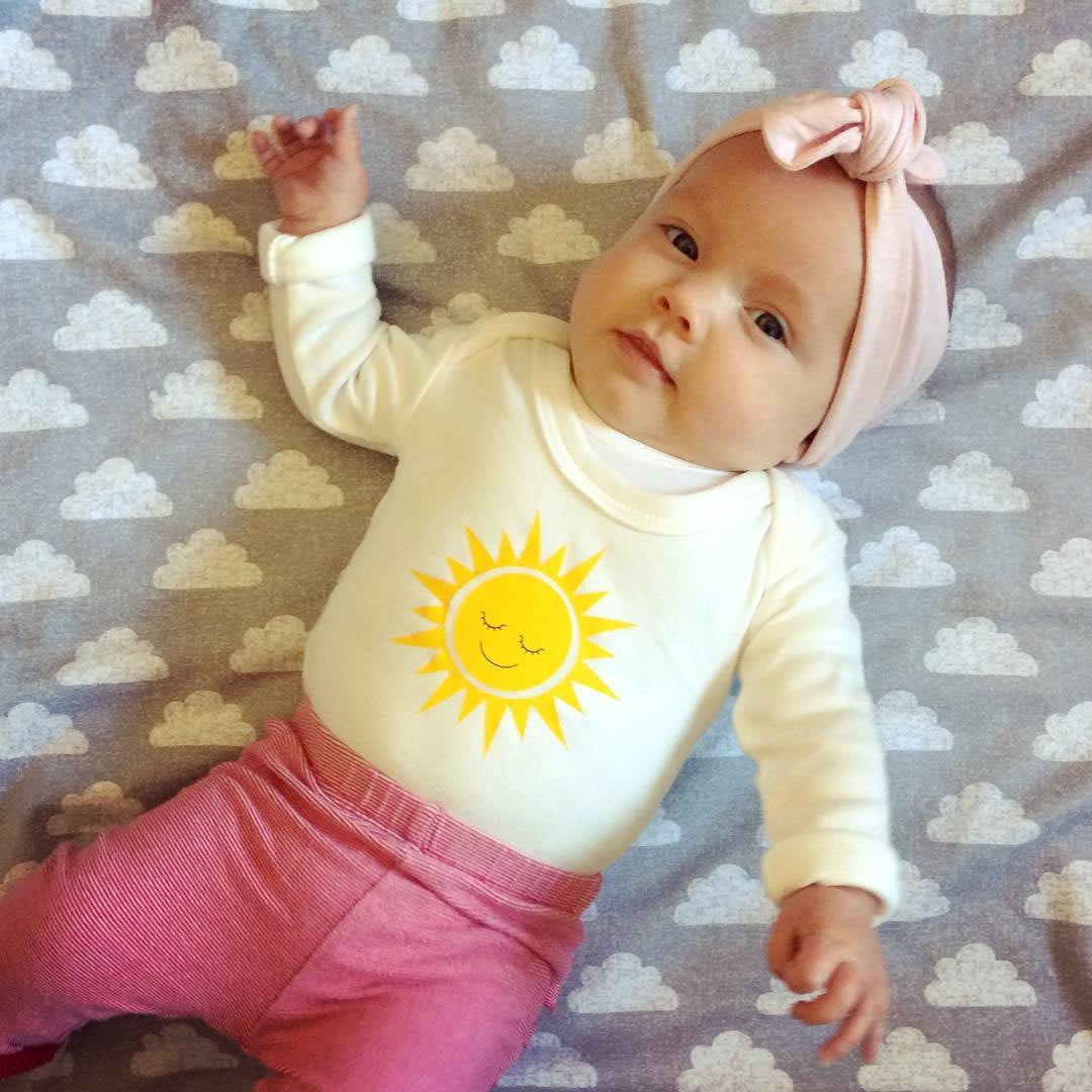 Lottie Piia wearing Mini Suzie London Happy Sun babygrow