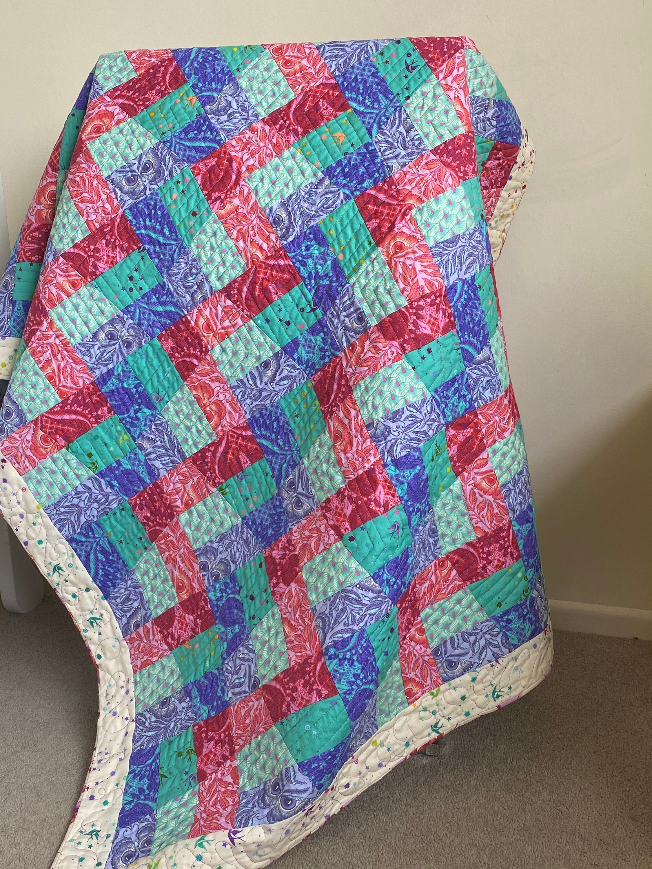 Rail Fence Quilt draped over a stand.