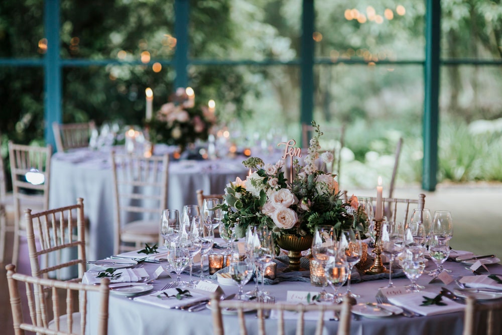 Wedding table reception with tiffany chairs and calligraphy menus