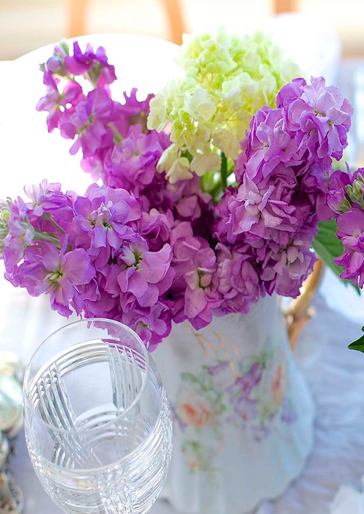 Flowers chosen to match the colors in your favorite china pieces set in a lovely vintage or antique pitcher adds a true summertime feel.