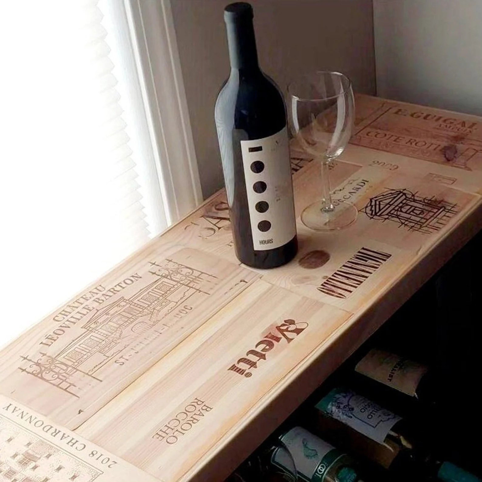 Close-up of a handmade wooden wine rack featuring authentic wine crate panels with vintage winery engravings, adding history and sophistication to any home bar or dining space.