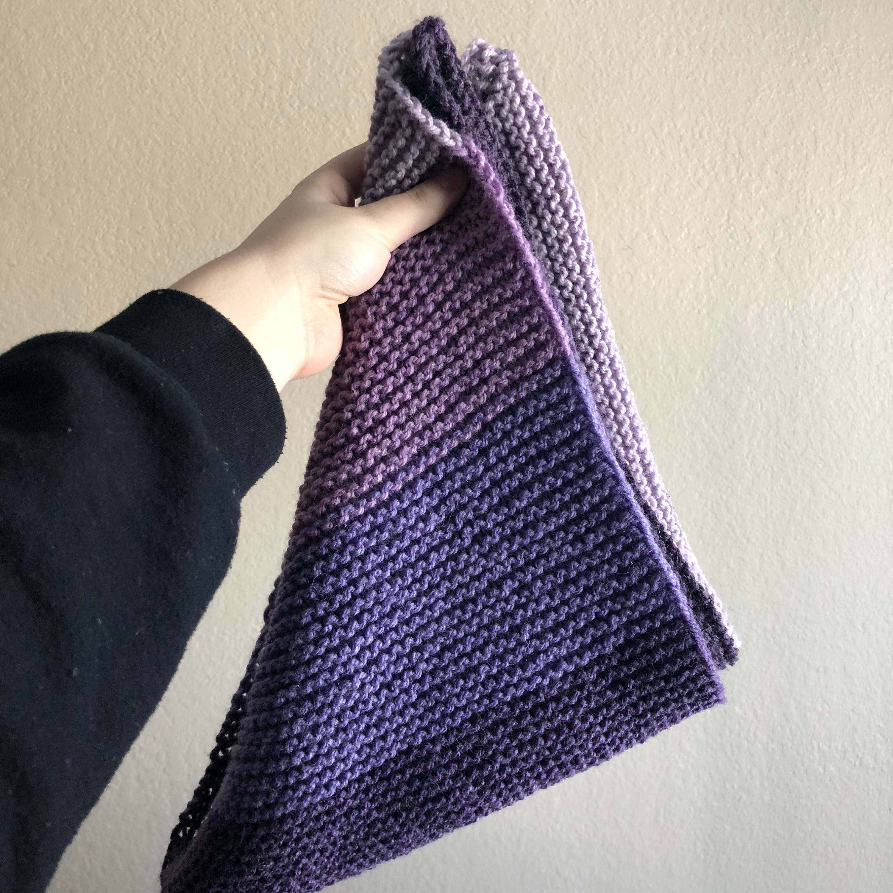 Person holding a knitted shawl