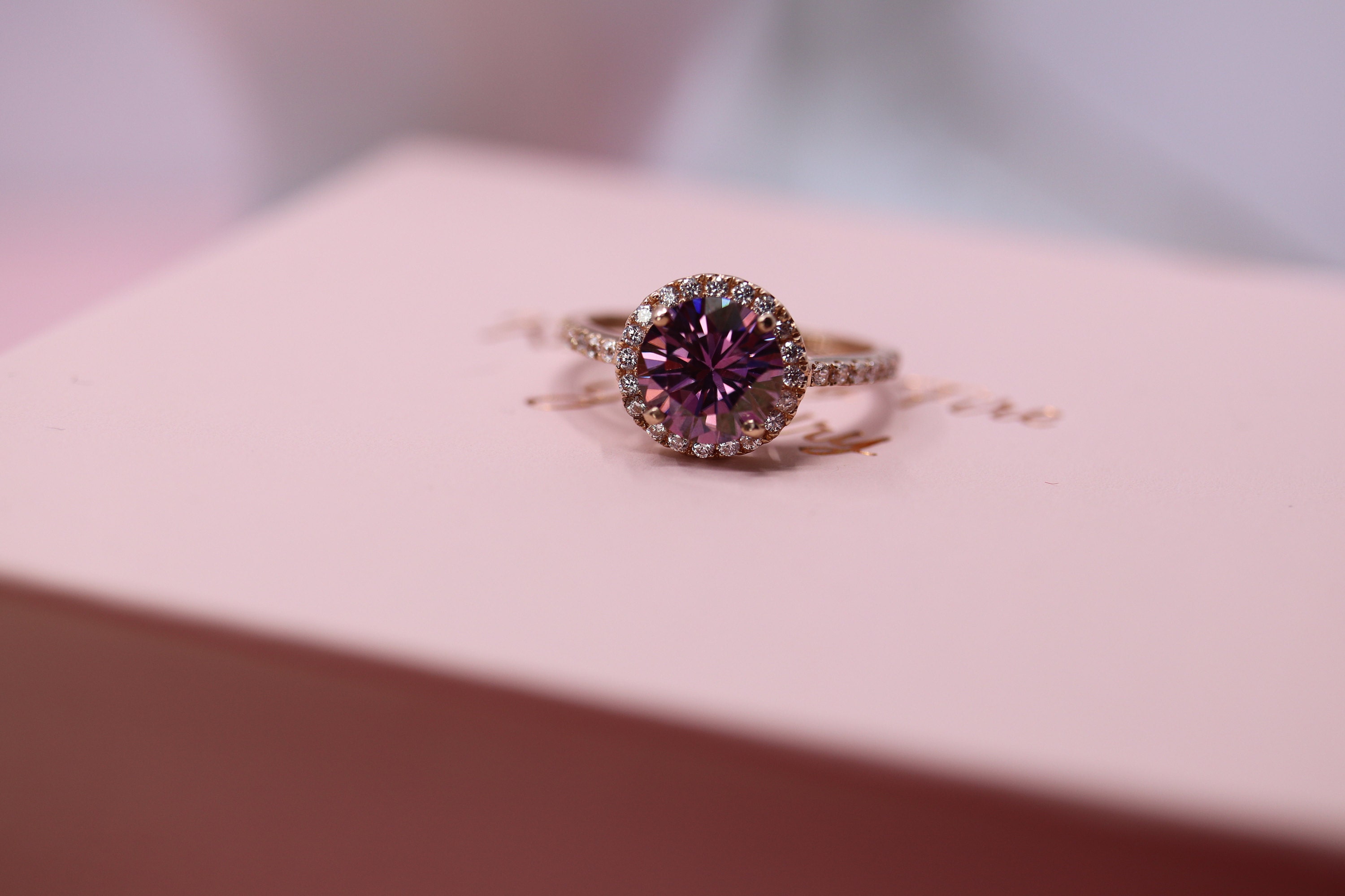 Halo 14k gold purple moissanite ring in rose gold with diamonds
