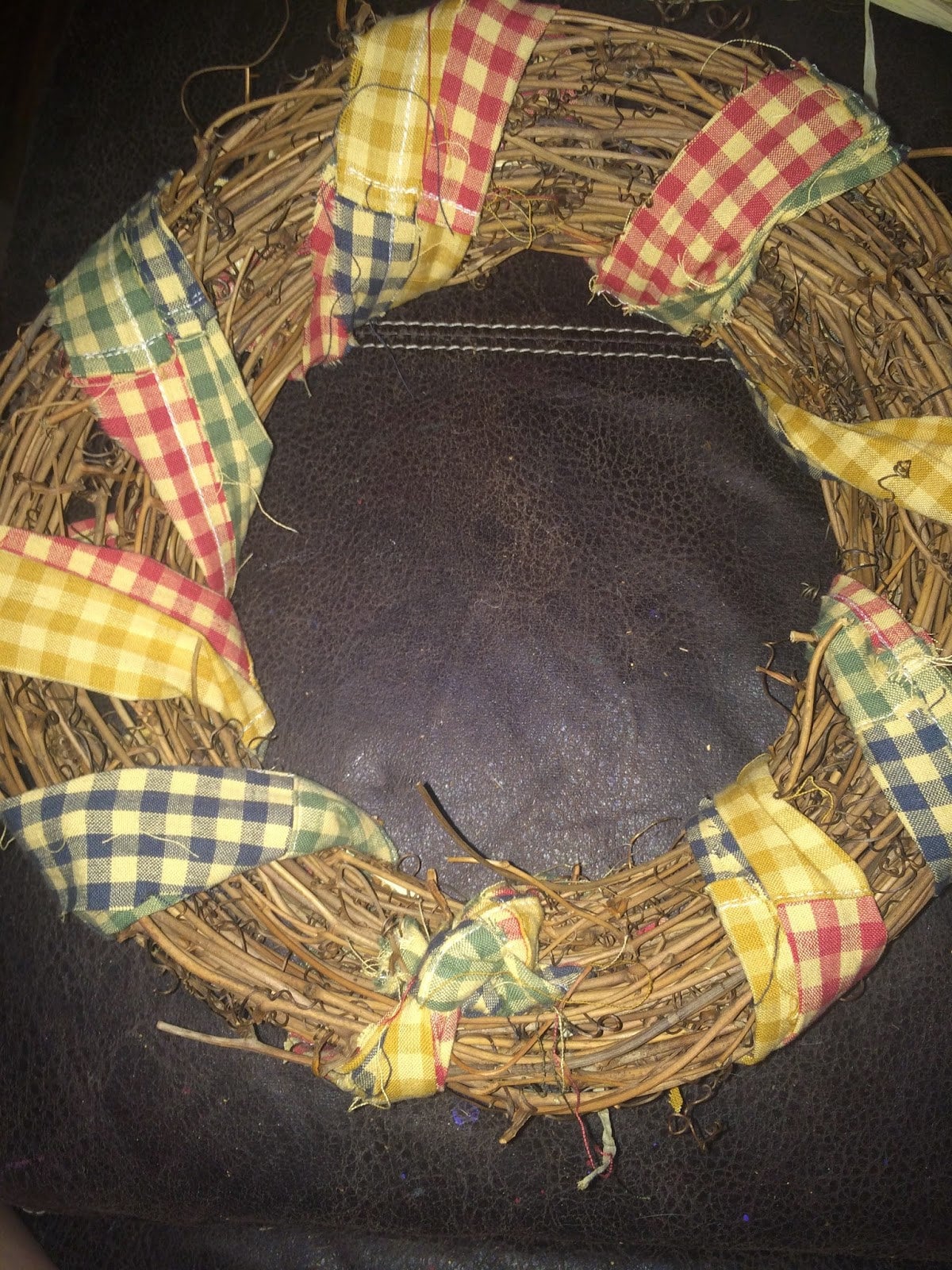 Fabric strips tied together and wrapped around the grapevine wreath
