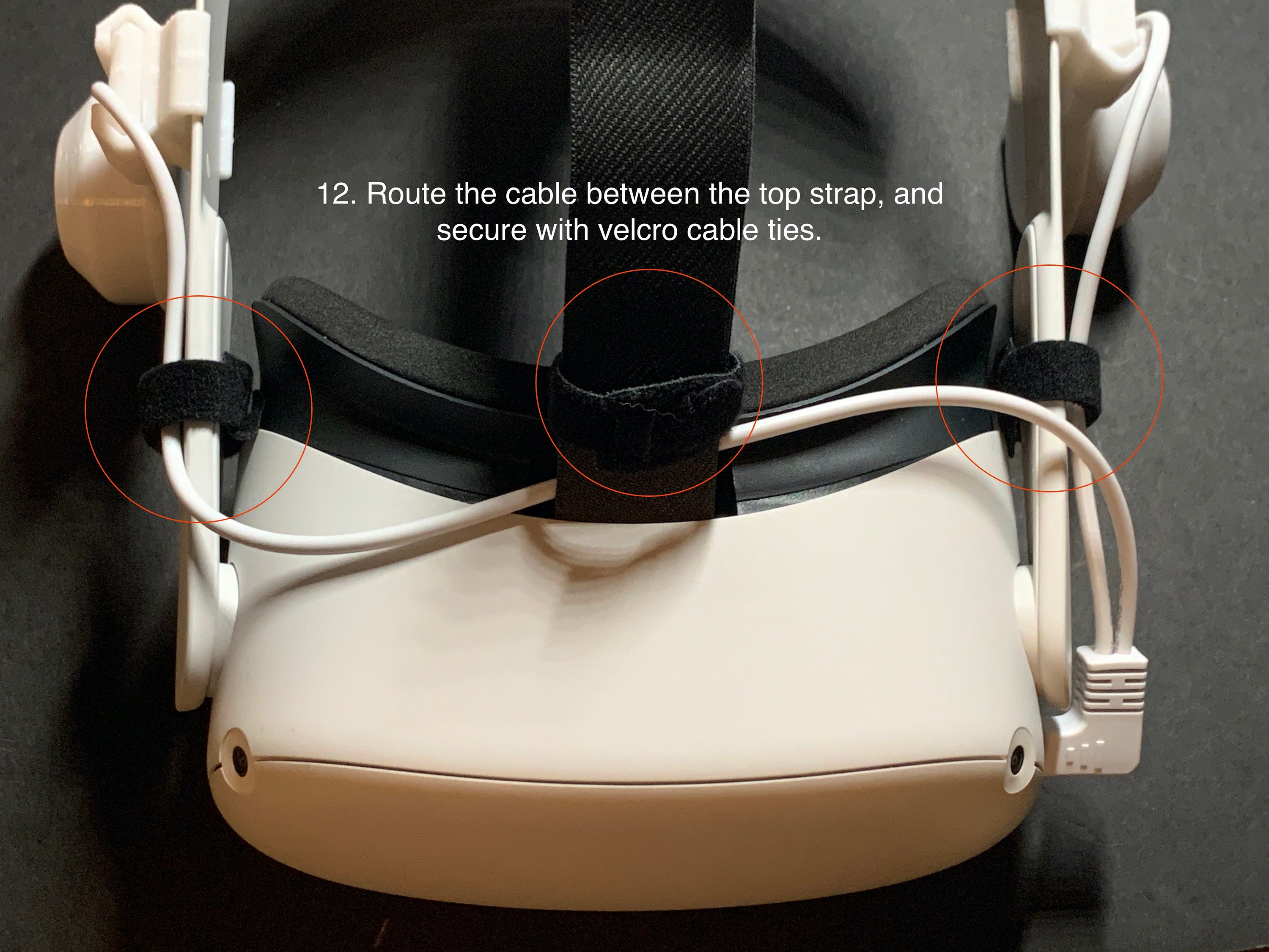 12. Route the cable between the top strap, and secure with velcro cable ties.