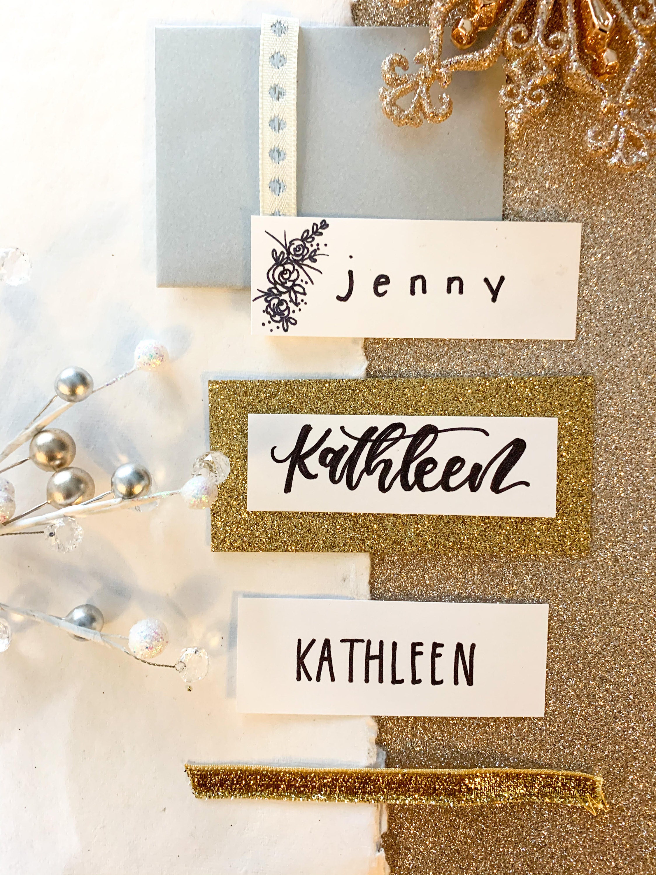Three place cards. The first one is written in lower case, the second one is written in script, and the third one is written in capital letters with the same x-height