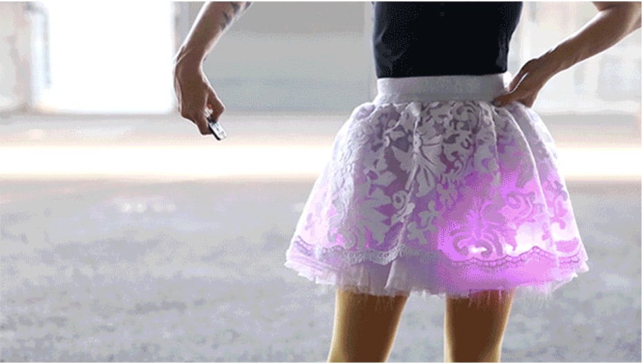 Girl with remote controlled glowing skirt