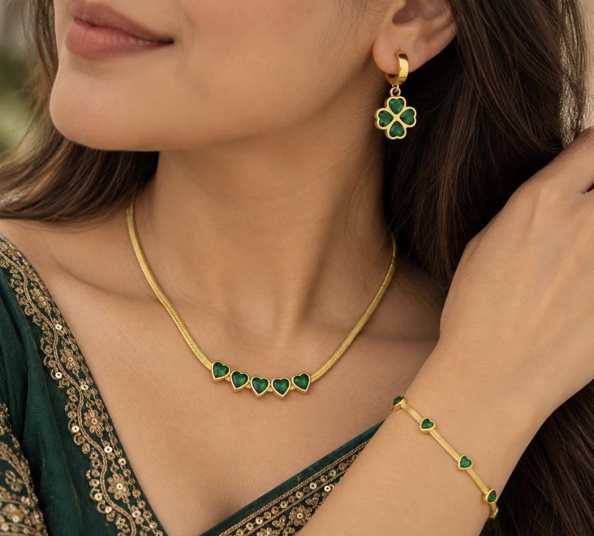 18K gold waterproof four-leaf clover jewelry set featuring a pendant necklace, matching bracelet, and stud earrings on tarnish-free stainless steel.