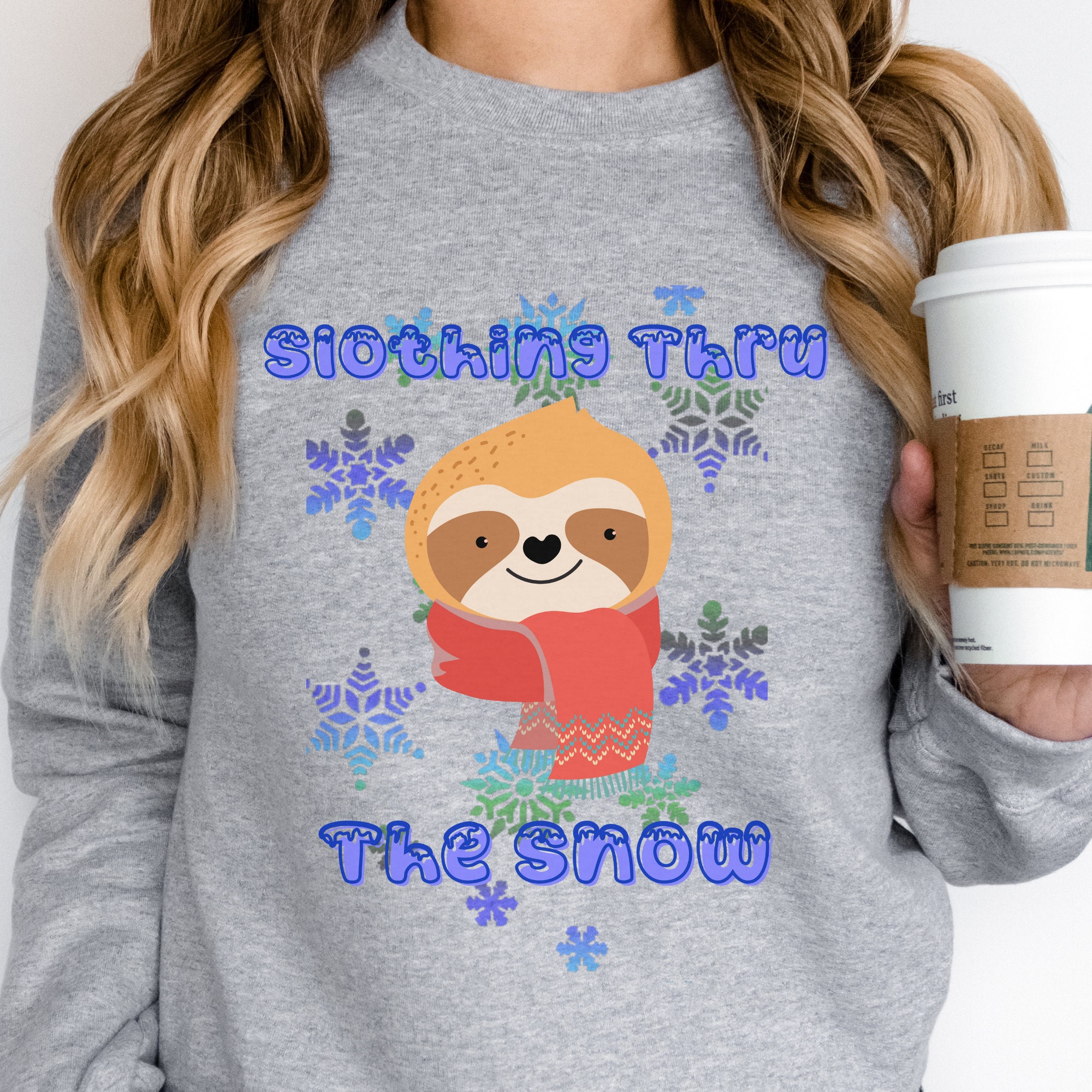 Slothing Thru the Snow cute smiling  sloth with a red scarf and a blue snowflake back ground