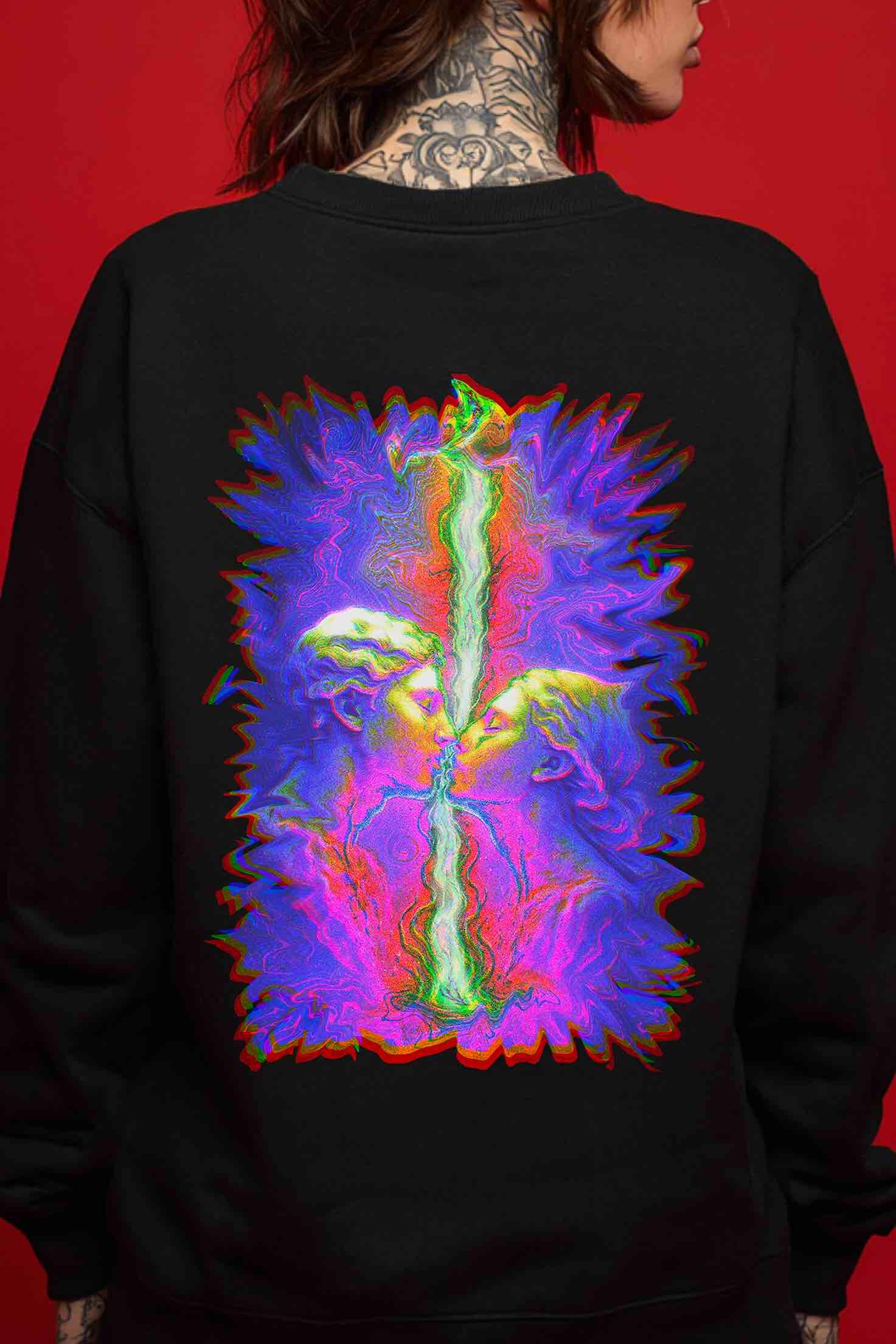 Back view of a black Gildan 18000 sweatshirt worn by a female model; full-back neon psychedelic lovers-kiss graphic with vertical energy beam. Studio red background, unisex streetwear for rave culture.