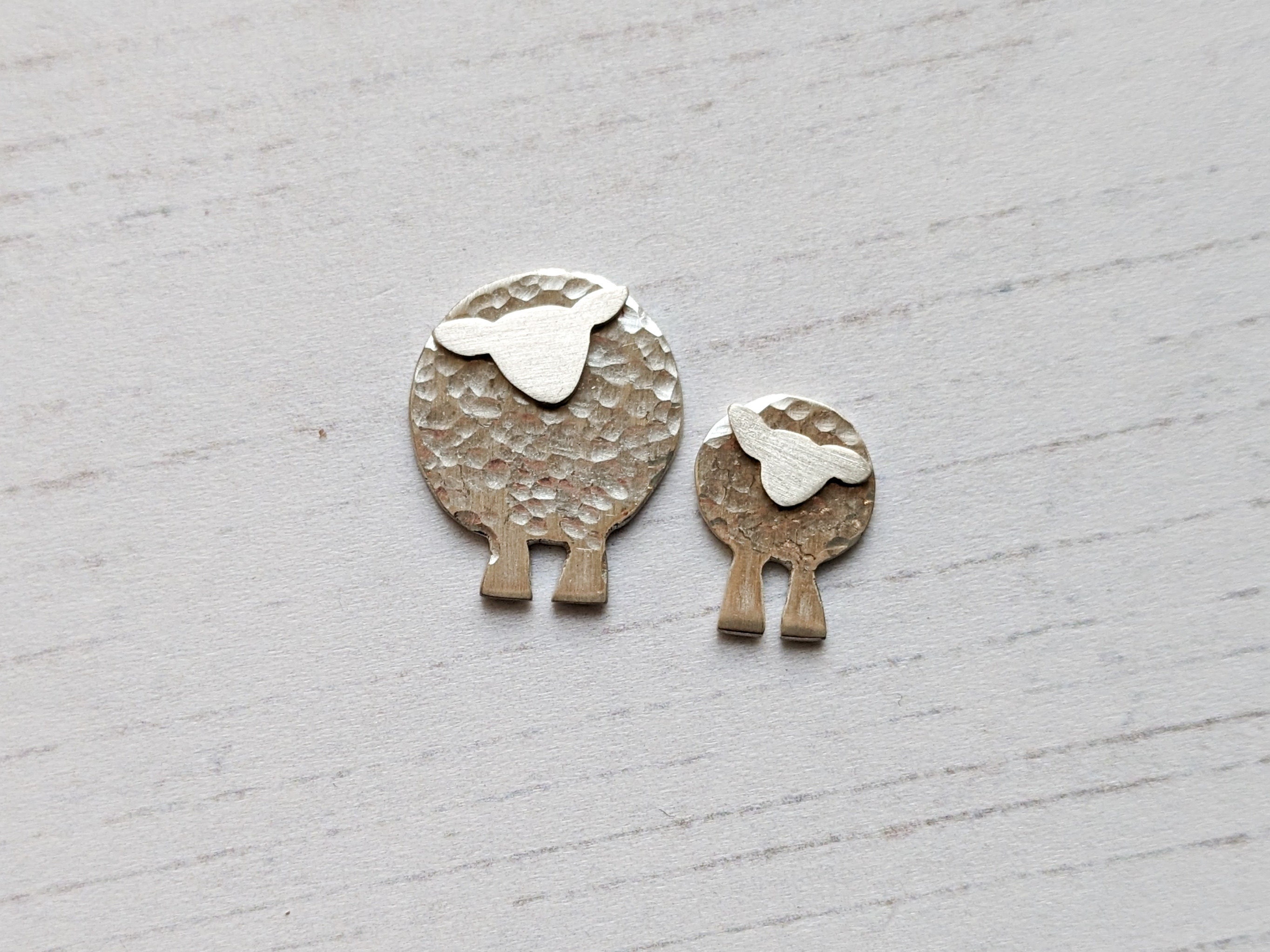 Colour photograph of a silver sheep and silver lamb
