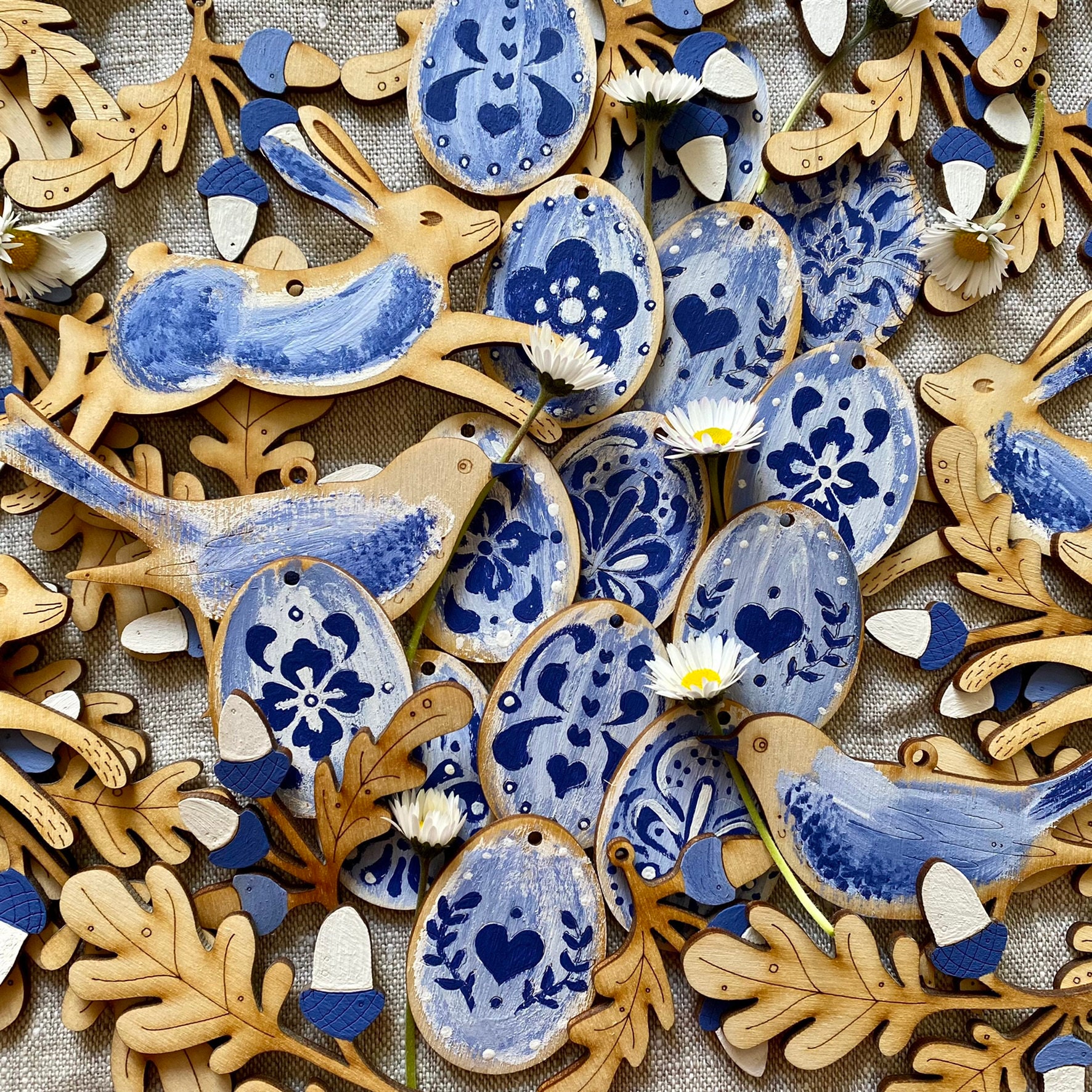 Easter decorations. Hares, Birds and Hand Painted Wooden Eggs in Blue and White Colours