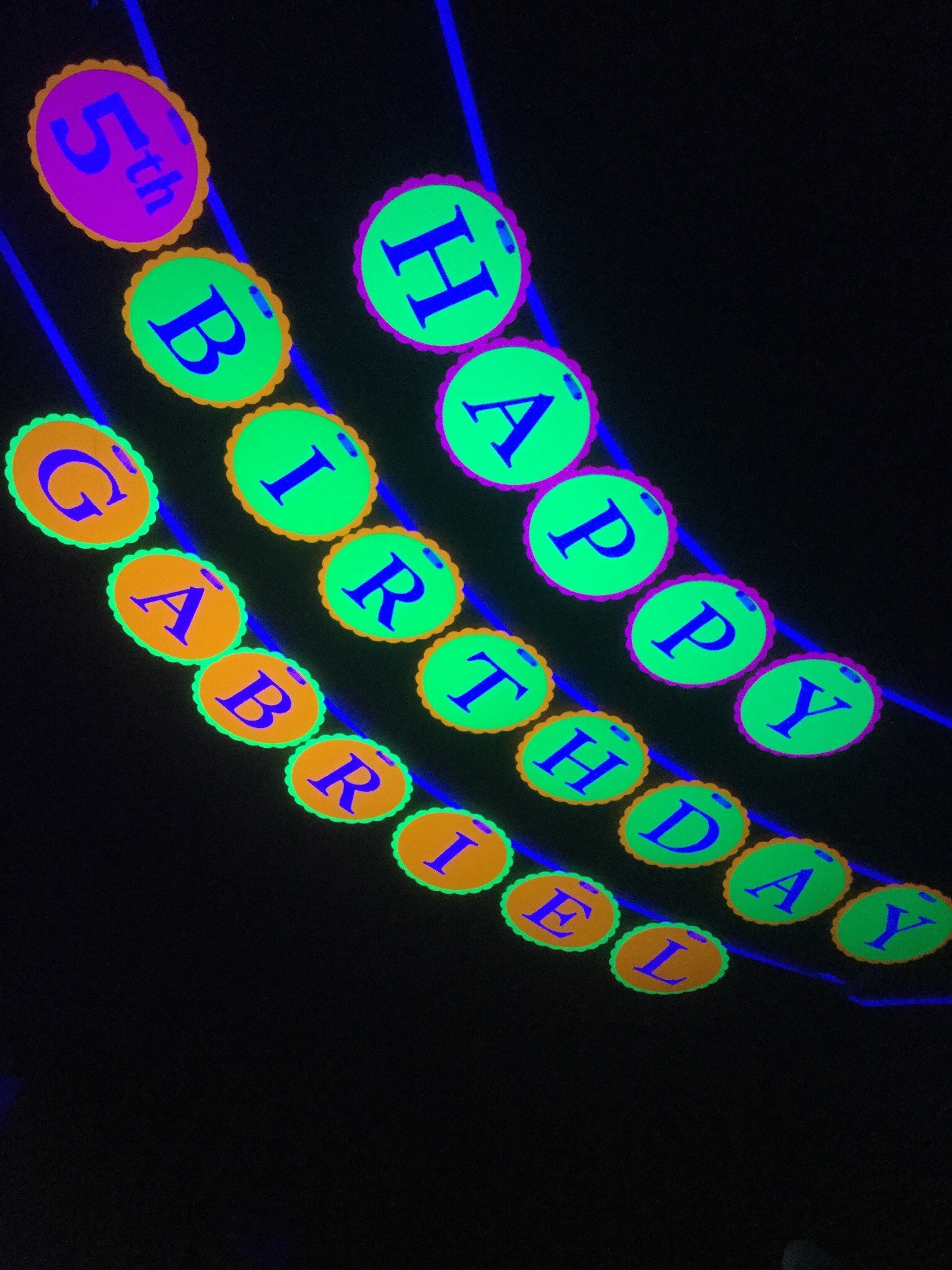 4 circles in neon colors with HAPPY BIRTHDAY GABRIEL for glow black light party