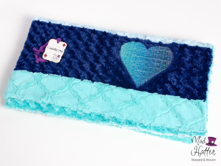 Mad Hatter Warped & Woven minky blanket with strips of blue minky in different shades and a matching handwoven wrap scrap heart.
