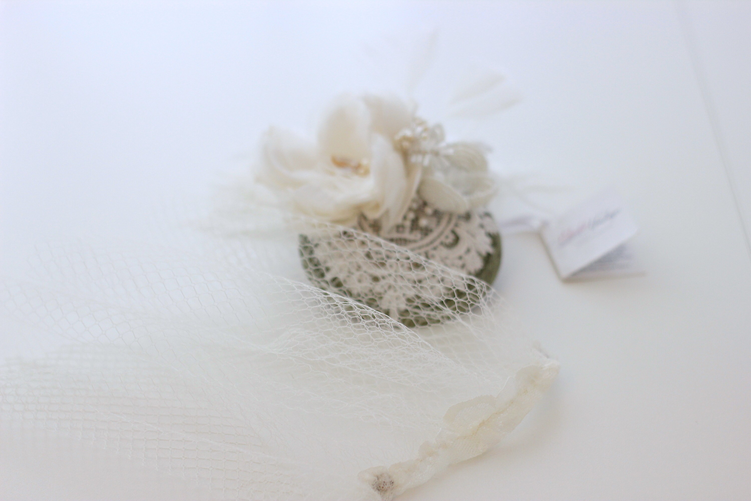 Versatile fascinator with removable birdcage veil, by Elizabete Munzlinger.