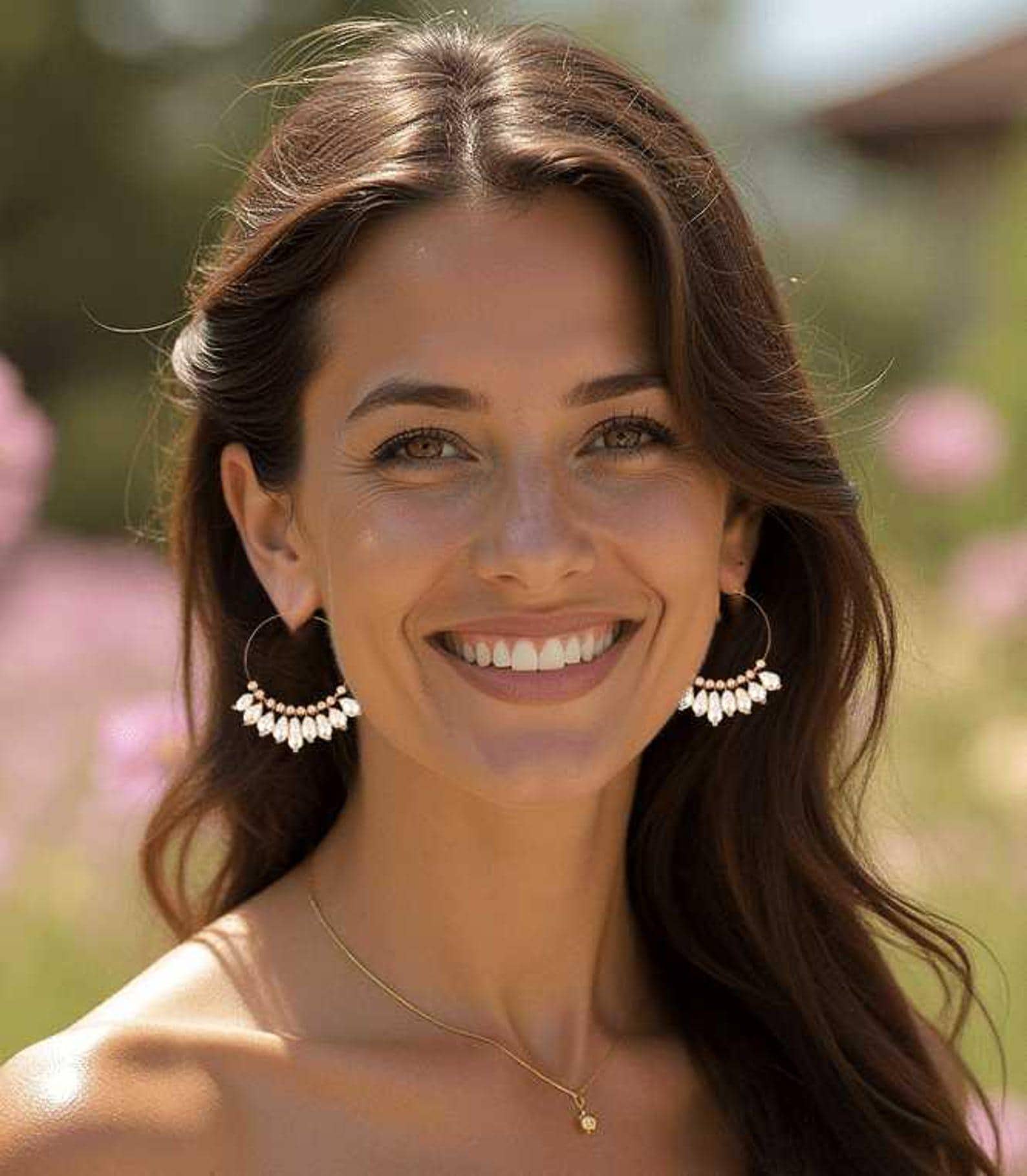 Woman wearing rose gold wedding jewelry, baroque pearl hoop earrings