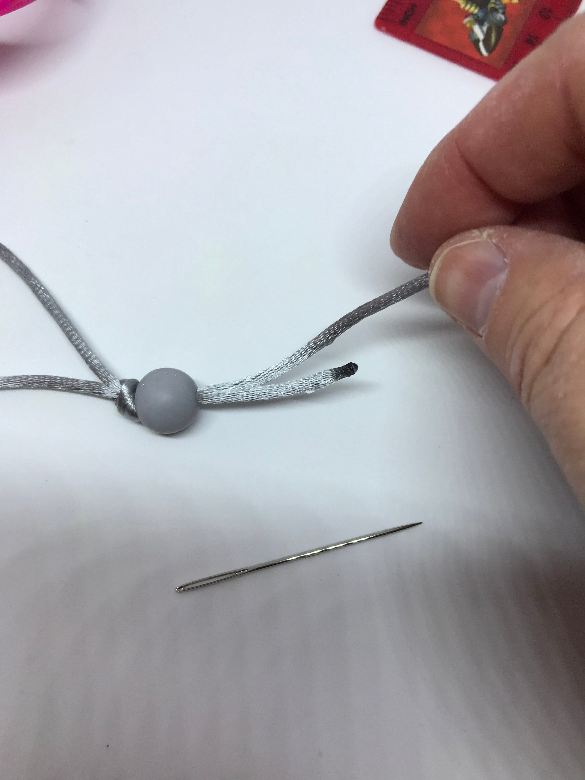 The bead next to the knot.