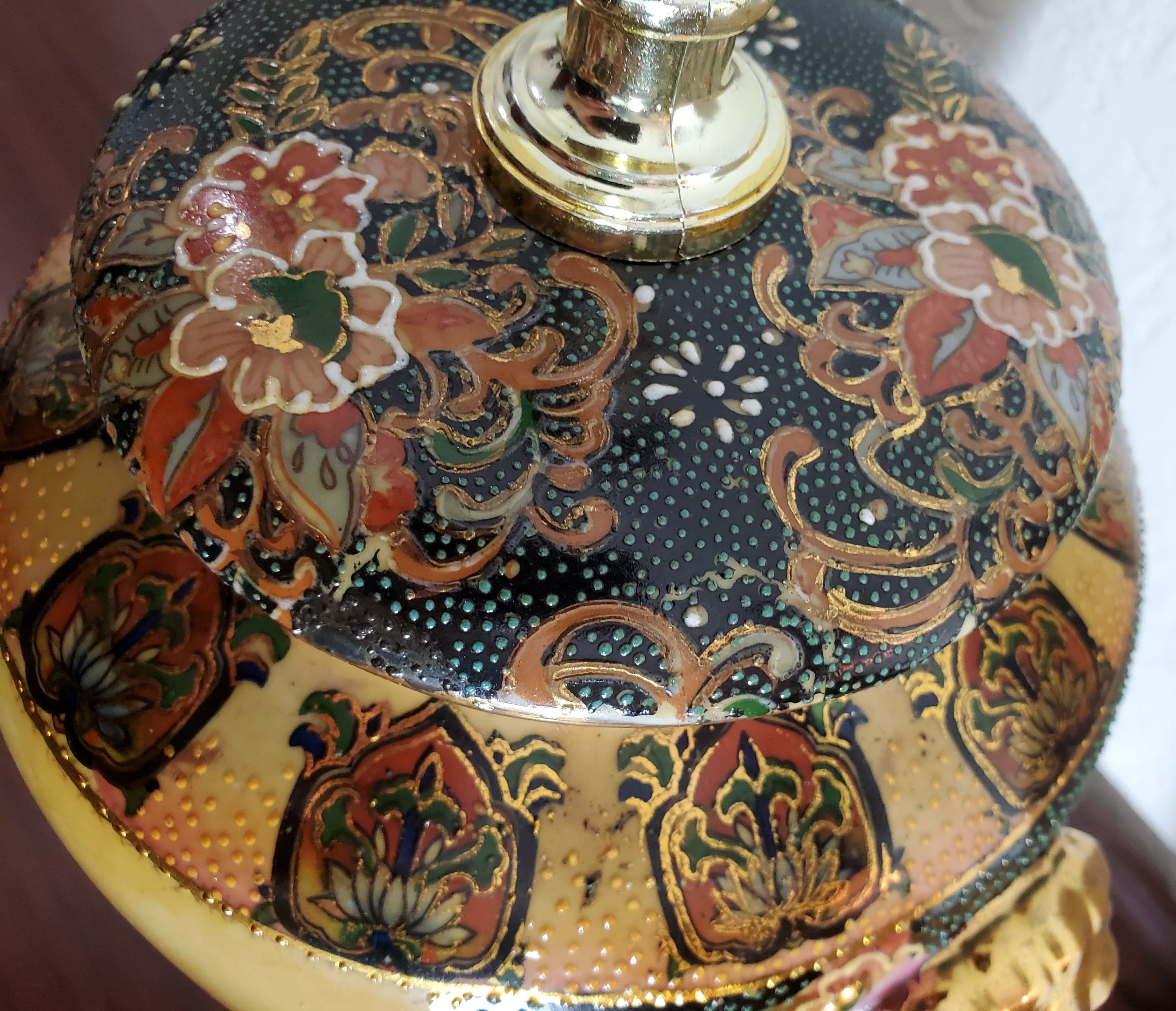 The moriage technique, made from a mixture of clay and rice paste, adds a unique three-dimensional texture to the design and creates a stunning depth and richness to the scene depicted on the vases.