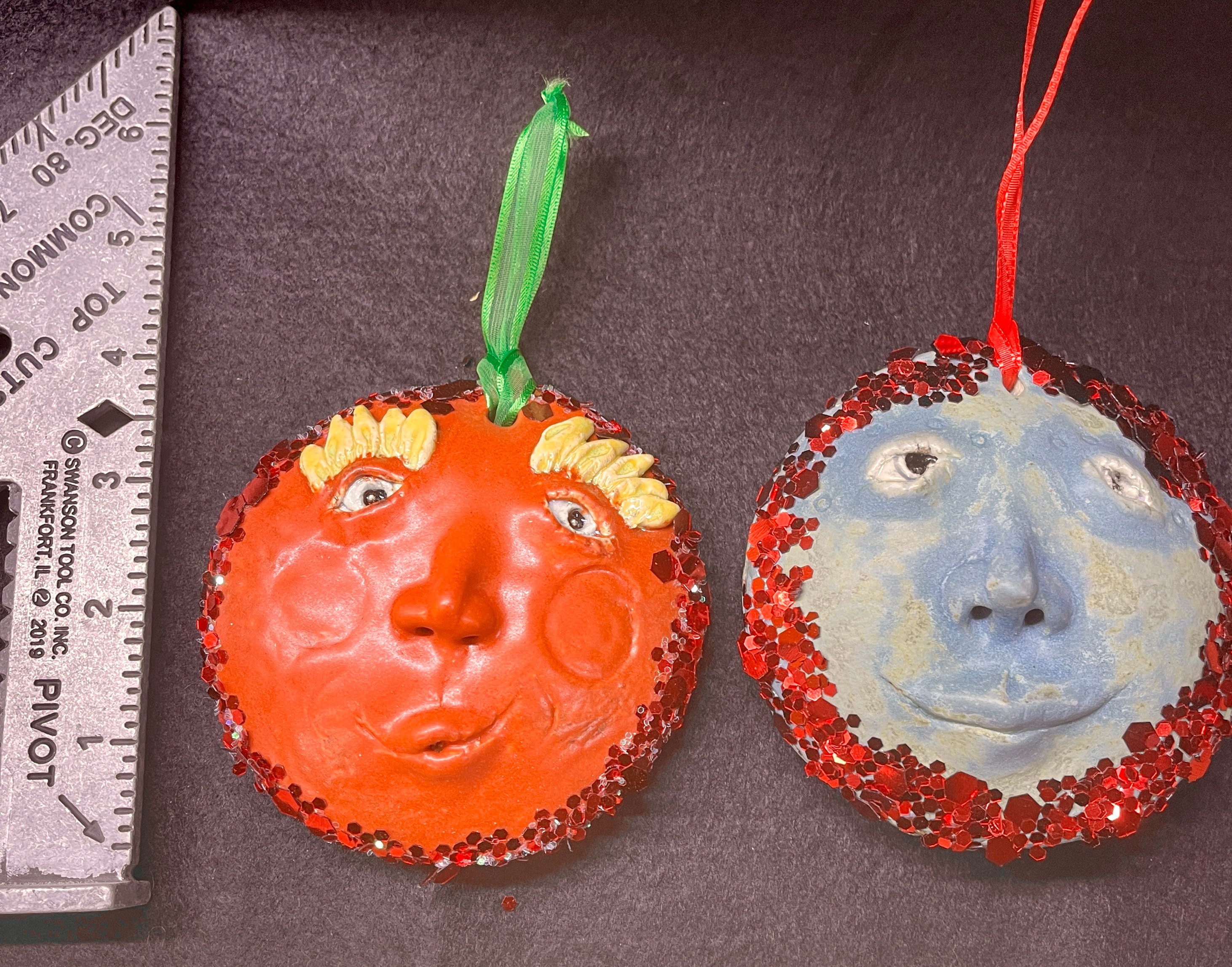 Two large face ornaments