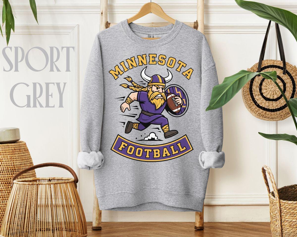 Close-up of the vintage-style Minnesota Football graphic with a running Viking character in bold purple and gold colors, holding a football and shield.