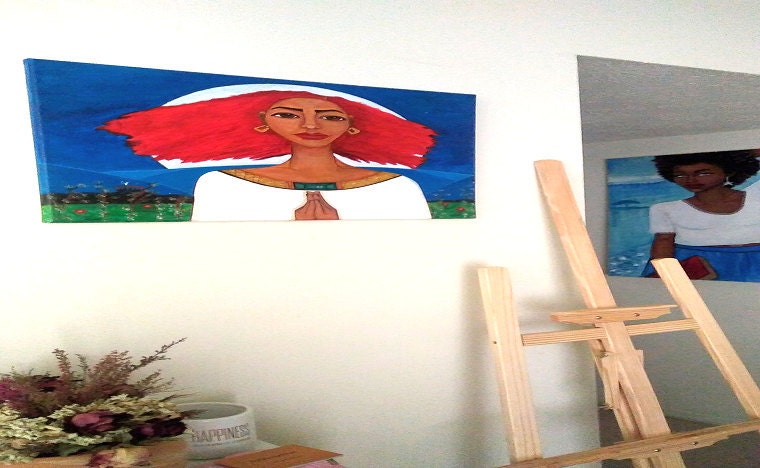 Two paintings hanging on the wall in a living room
