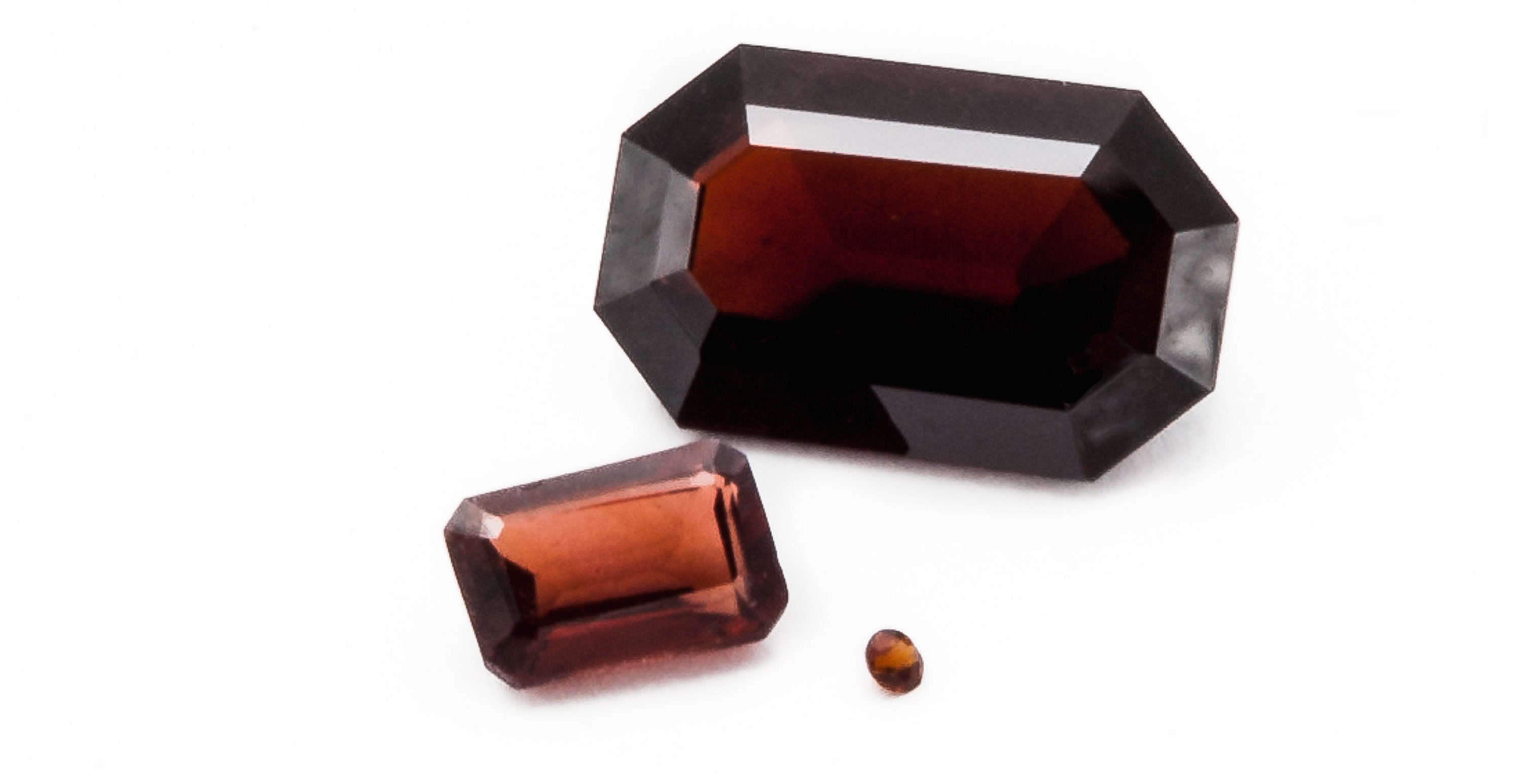 loose garnets very tiny round cut with very large emerald cut gemstones