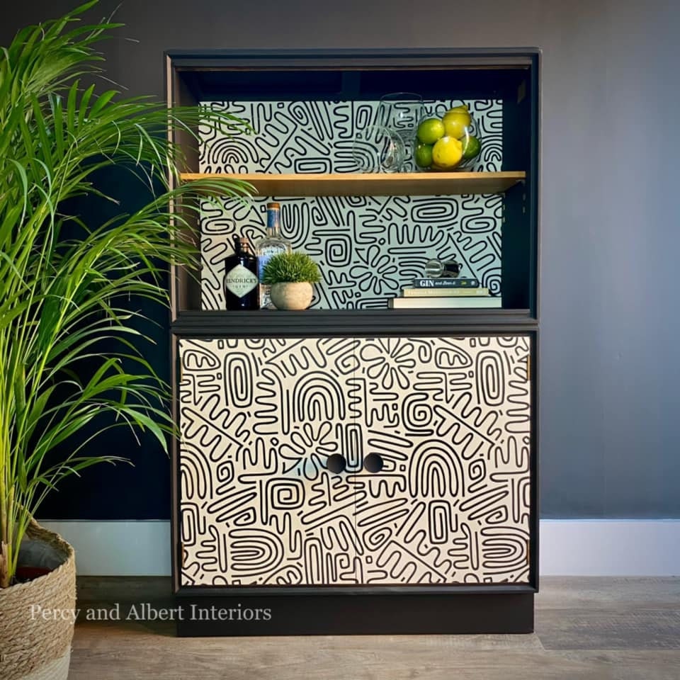 Black bookcase with graphic wallpaper