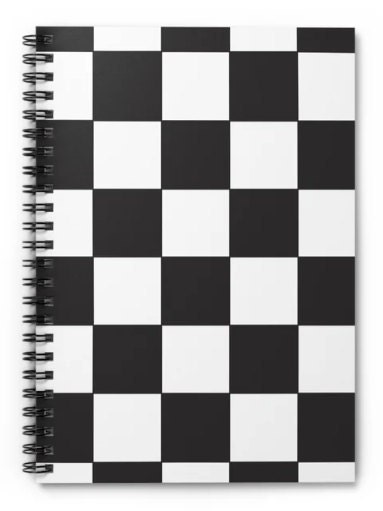 A notebook featuring a bold black and white checkerboard pattern on the cover with black spiral binding.
