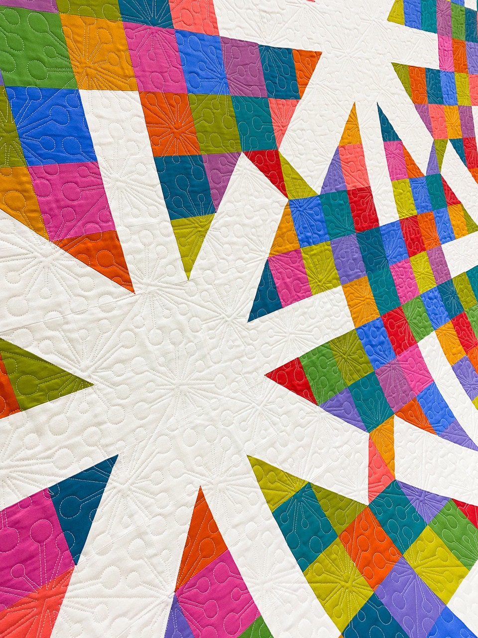 brightly colored patchwork squares in quilt