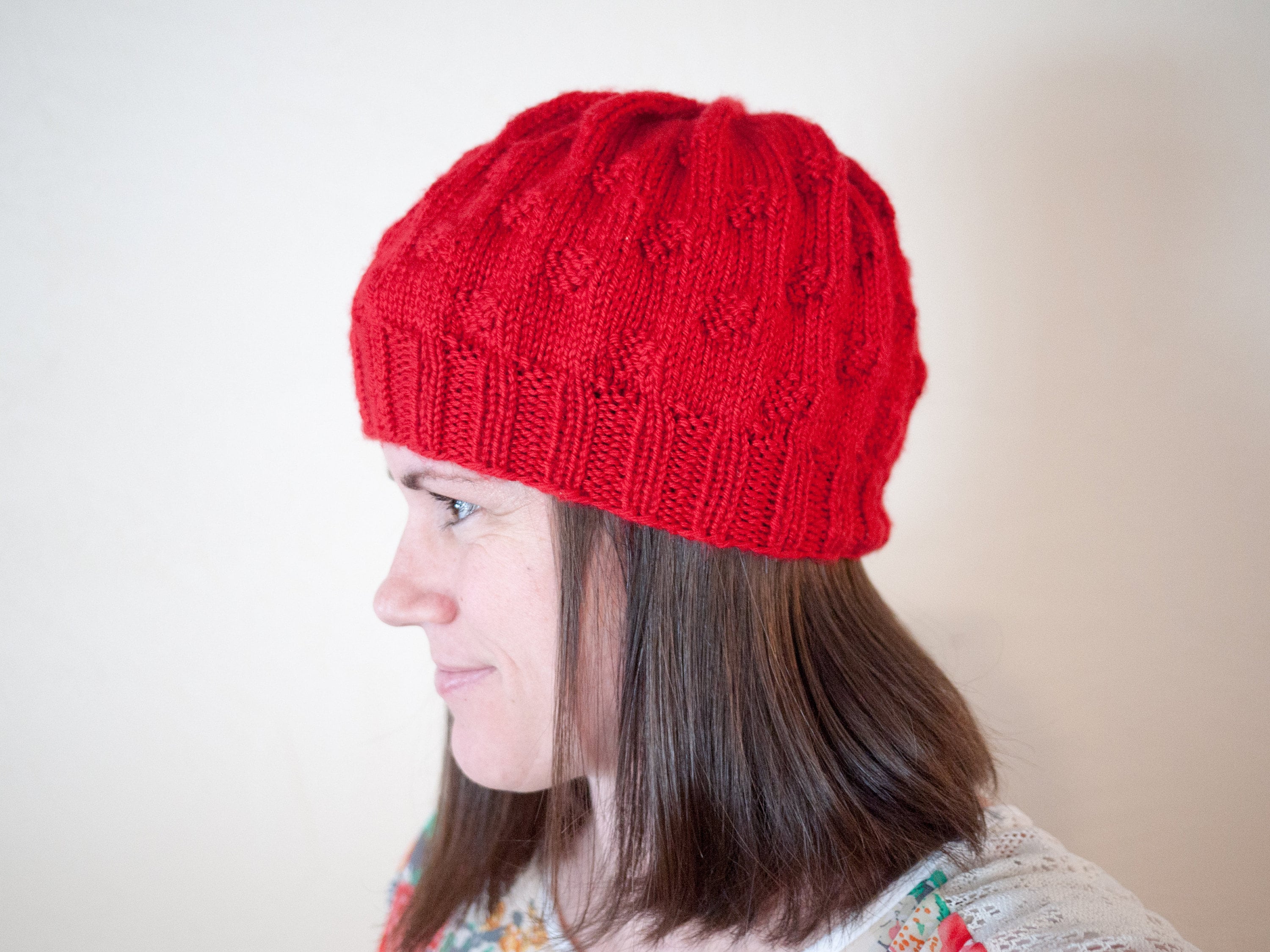 Side view of The Caitlin Hat in red.
