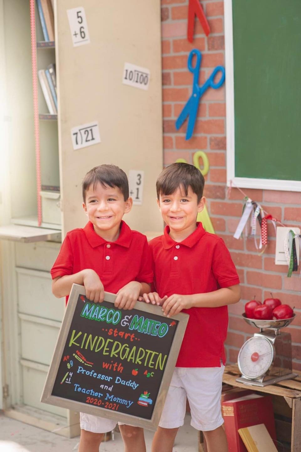 two boys holding one chalkboard