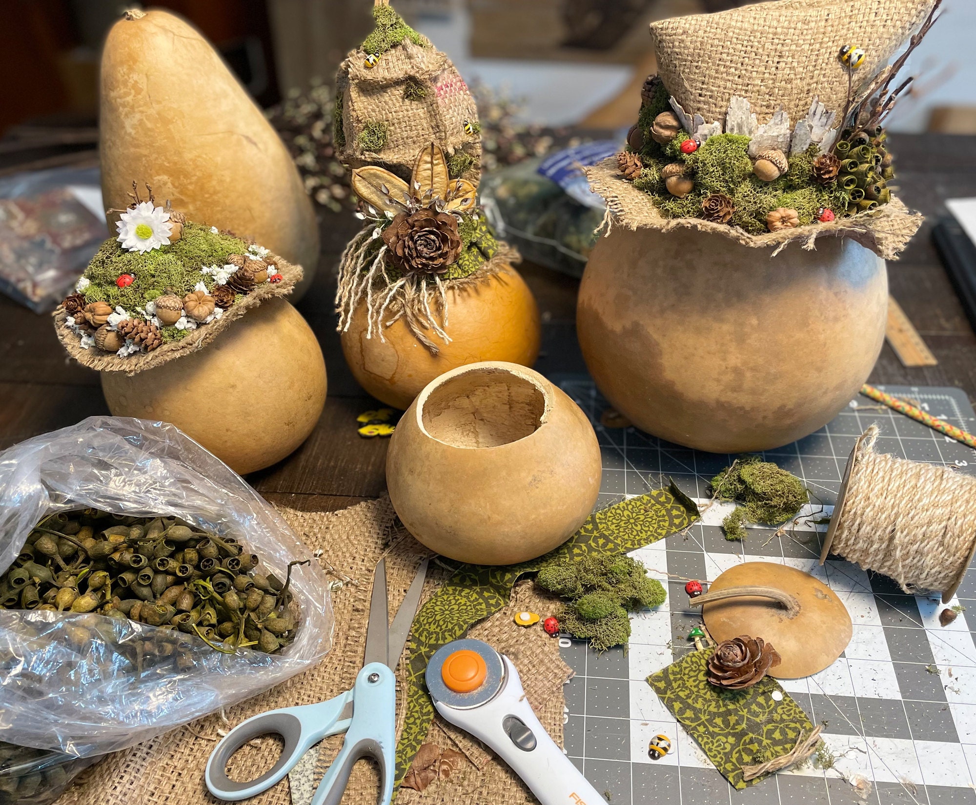 Dried gourds being made into woodland fairy decorations