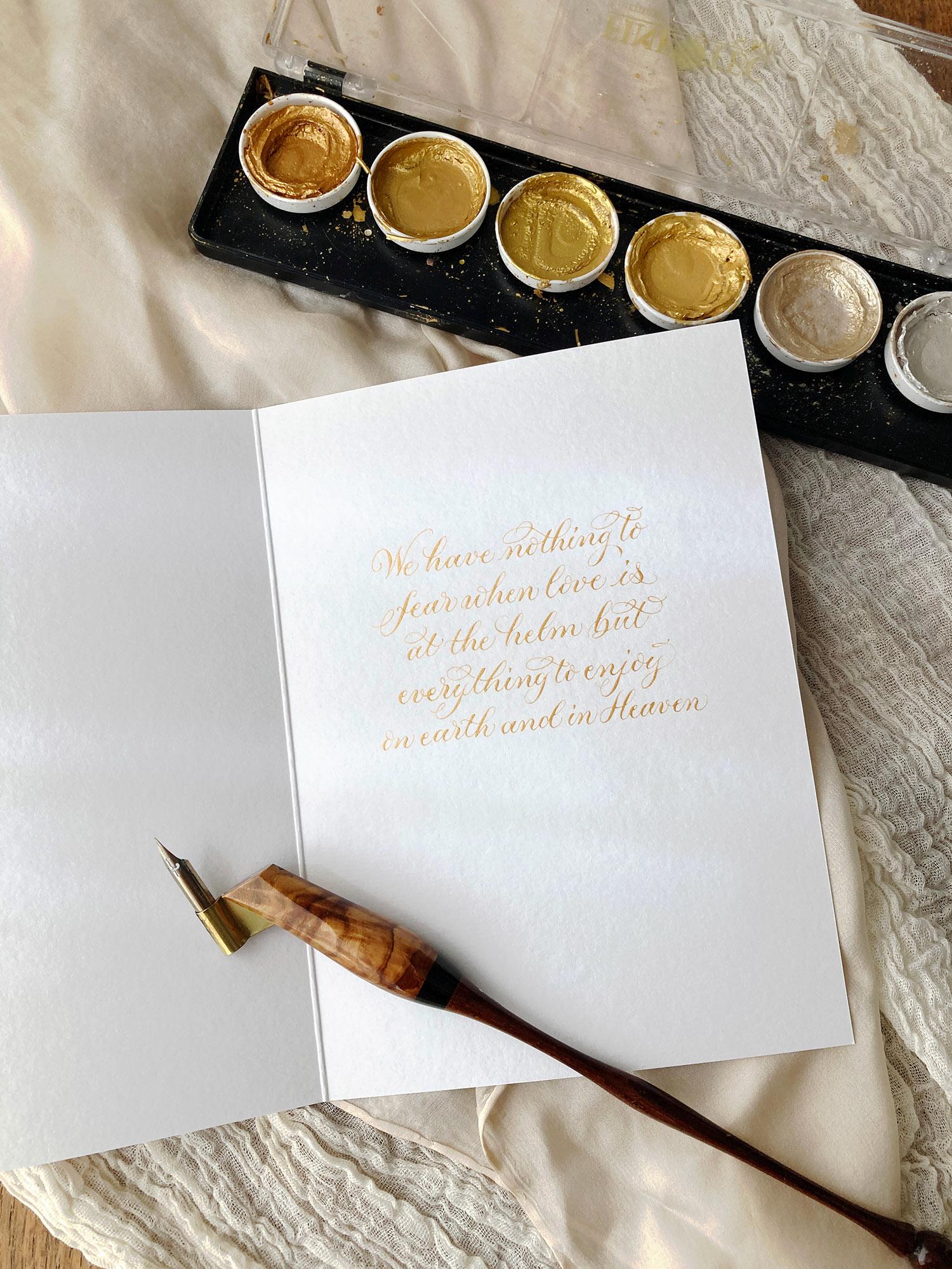 Calligraphy in gold inside a greetings card