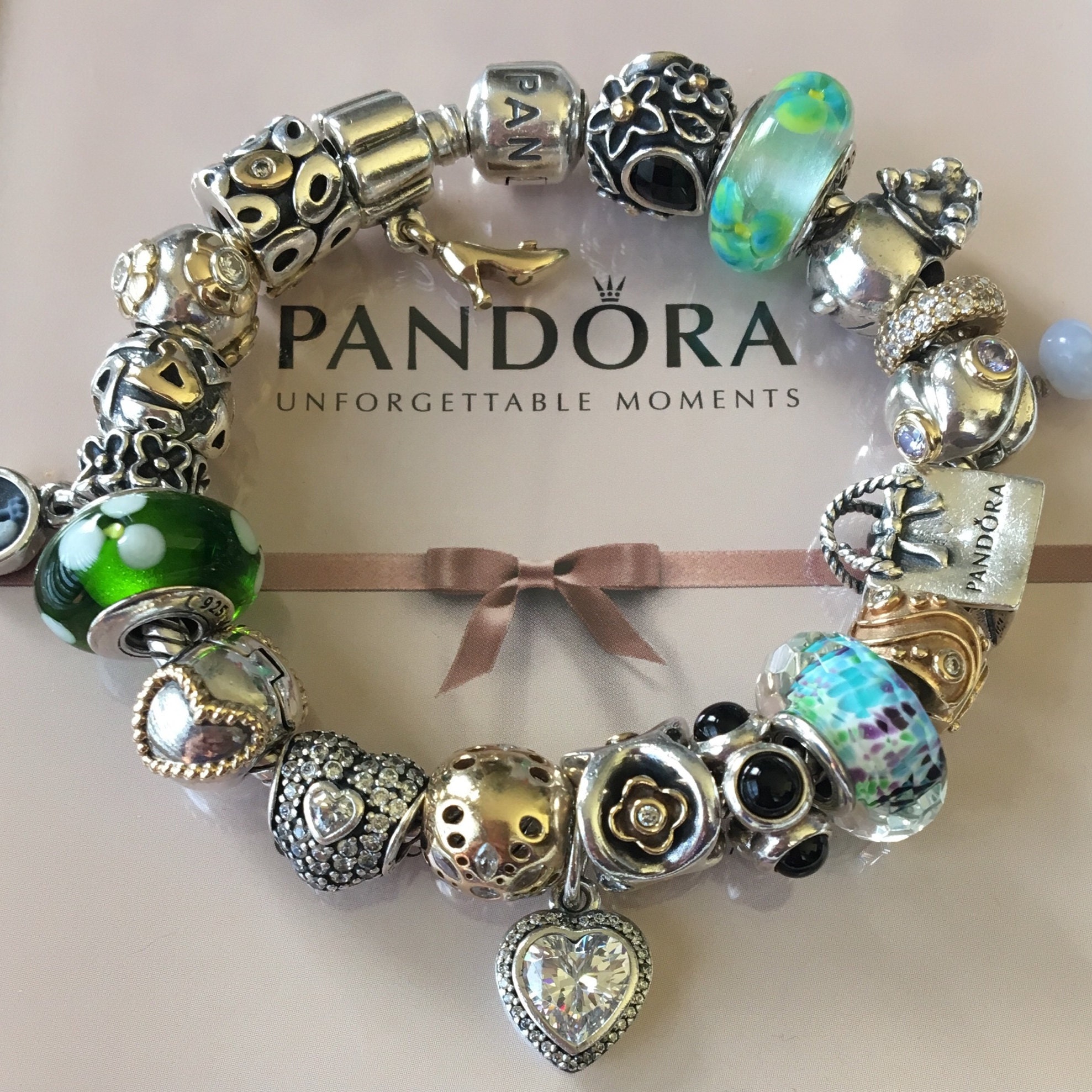 My first real beach find. Pandora sterling bracelet with 11 different charms.  I don't have the weight, but it's probably valued between $650-$750. :  r/metaldetecting