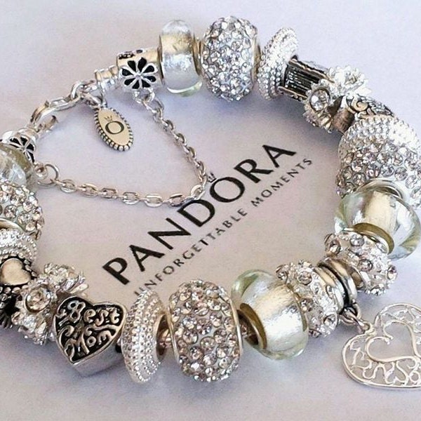 My first real beach find. Pandora sterling bracelet with 11 different charms.  I don't have the weight, but it's probably valued between $650-$750. :  r/metaldetecting